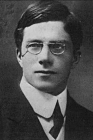 Photograph of Ronald Fisher as a young man in 1912, wearing a dark suit and round wire-rimmed glasses.